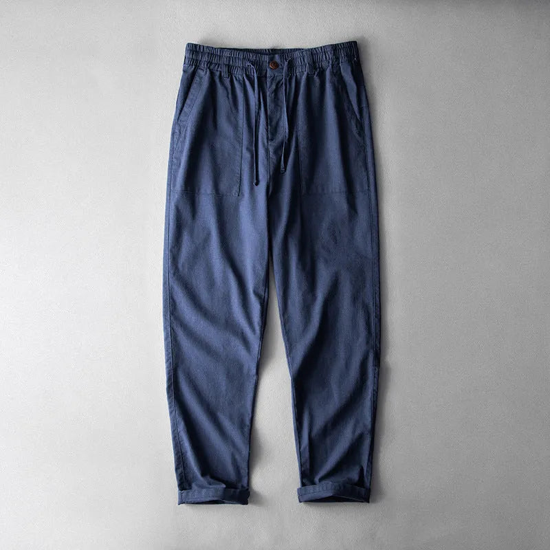 Men's casual linen trousers in a solid colour, shown in a mid-waist, full-length trouser style.