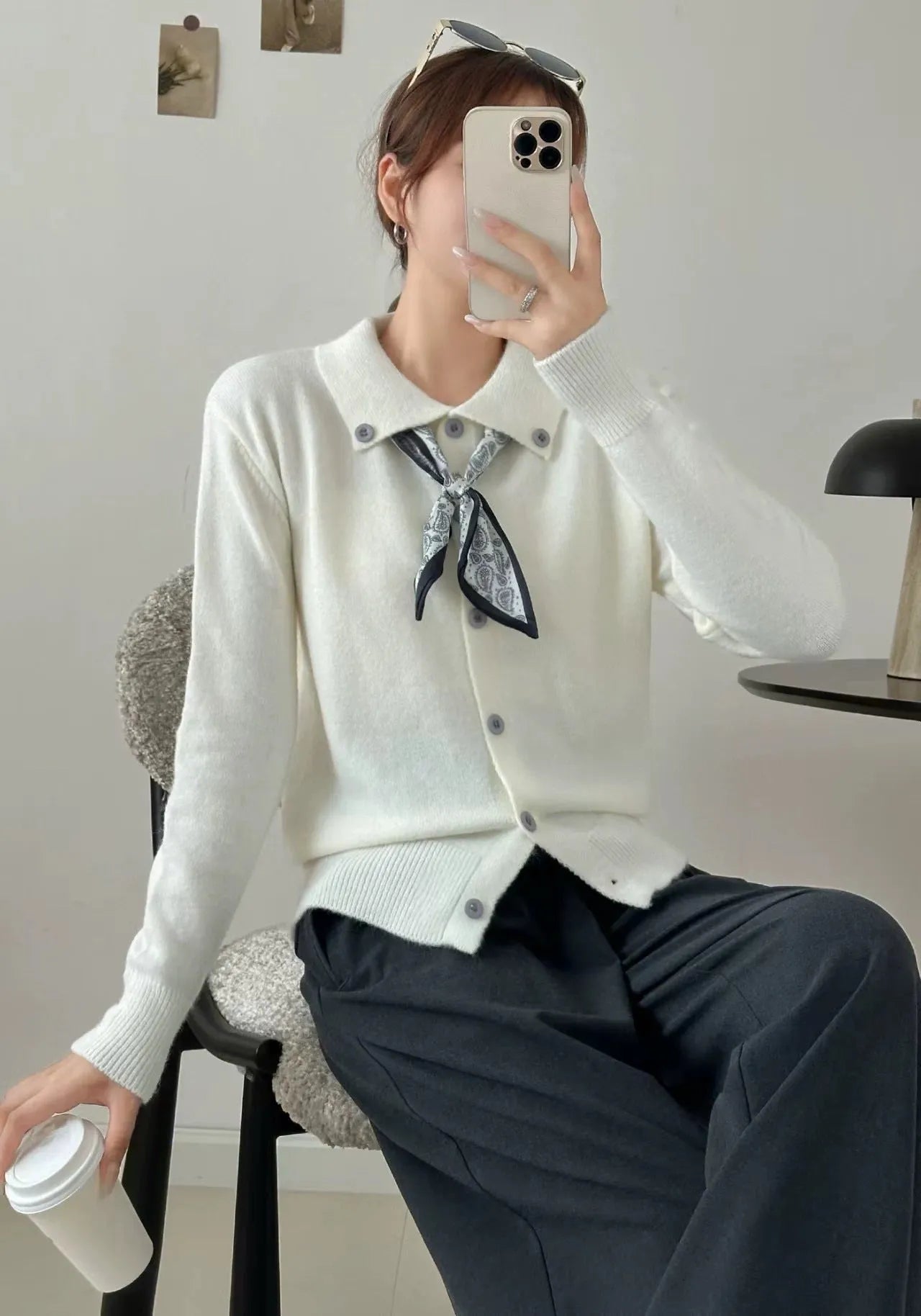 Women's beige lapel scarf collar acrylic cardigan sweater on a hanger.
