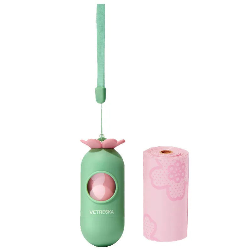 Portable dog poo bag dispenser capsule with strawberry design and a roll of scented biodegradable bags.