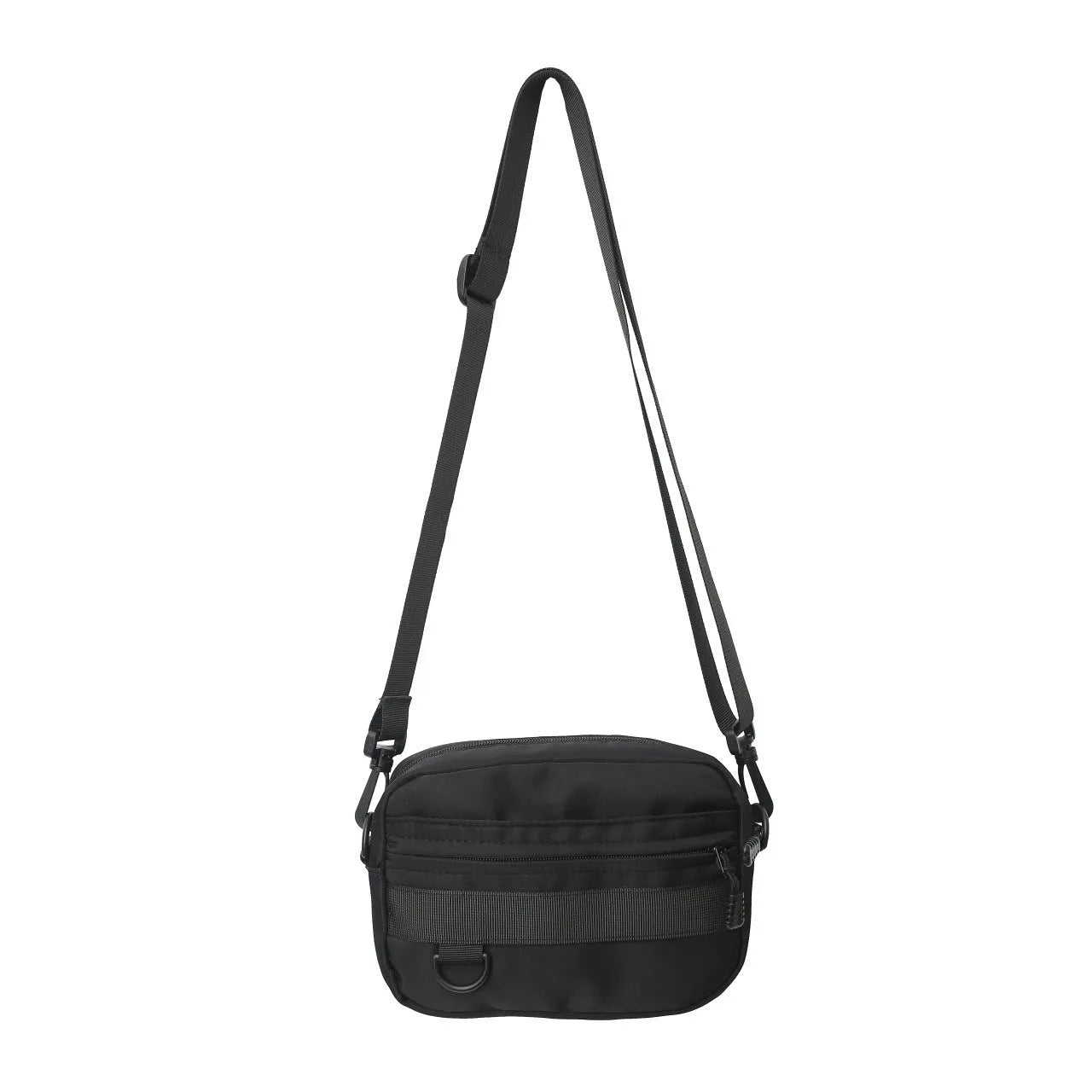 Men's solid colour nylon messenger bag with crossbody strap, shown in street style.