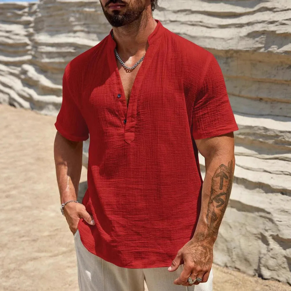 Men's solid colour stand collar short-sleeved casual shirt laid flat, showing slit detail and thin fabric.