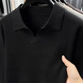 Man wearing a loose-fit green casual pullover sweater for autumn leisure.