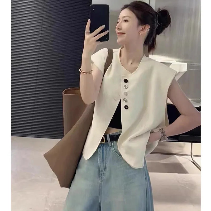 Women's loose-fit polyester vest in milky white, featuring pockets and a short 40cm length.