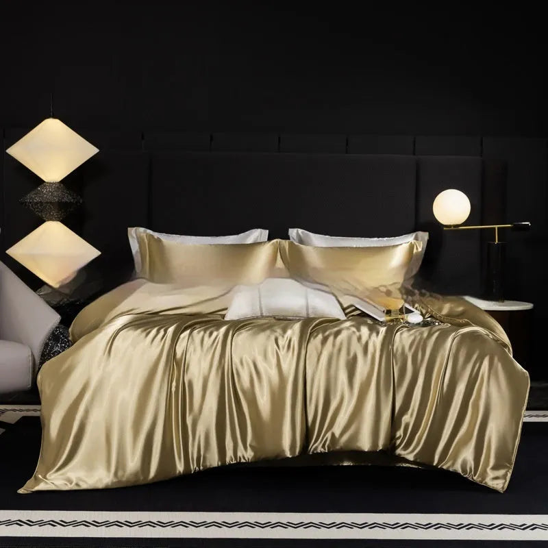 Solid colour silk bedding four-piece set shown in twilight blue on a bed.