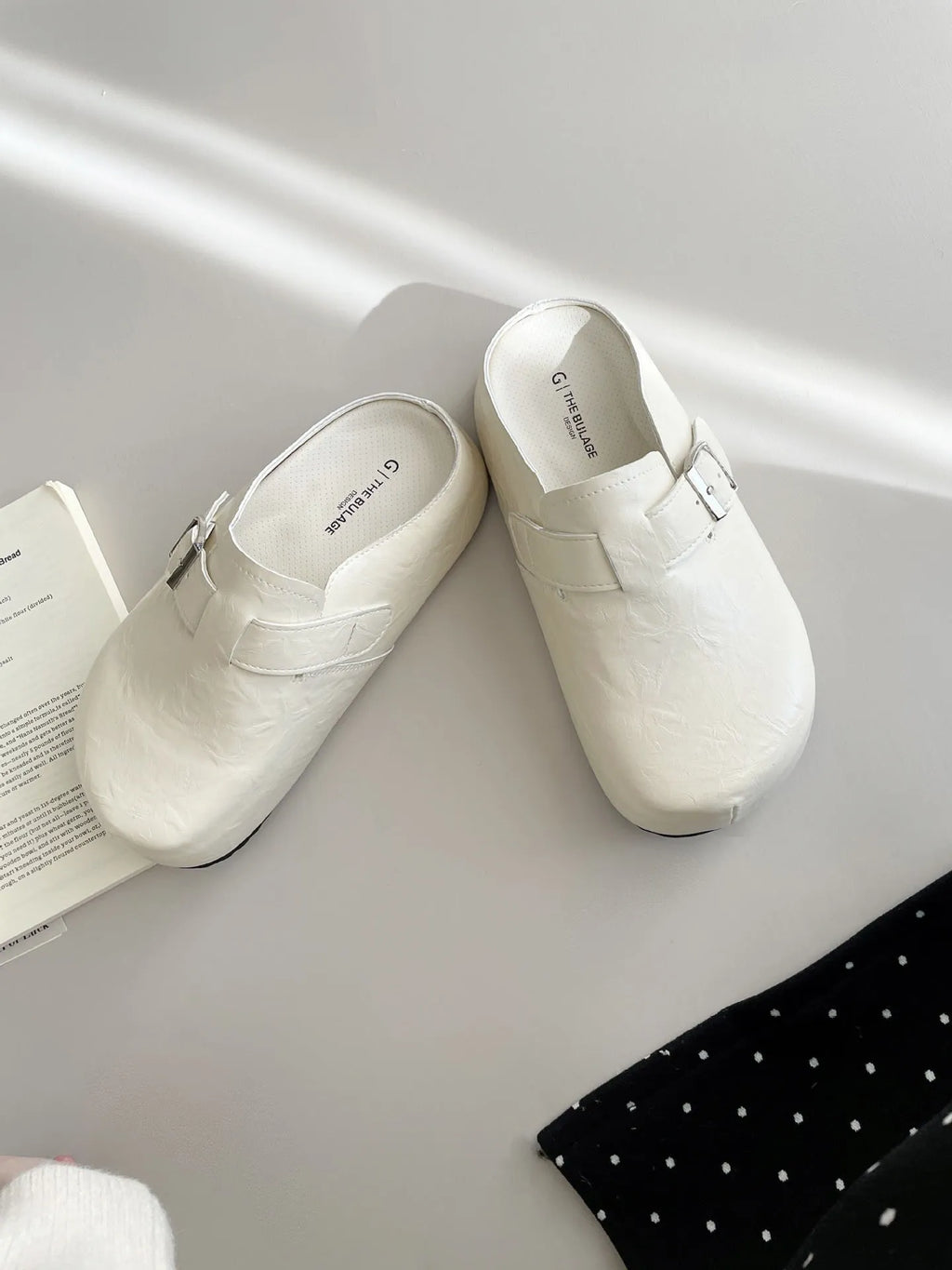 Flat buckle casual sneakers in yellow, black, silver, and creamy-white on a white background.