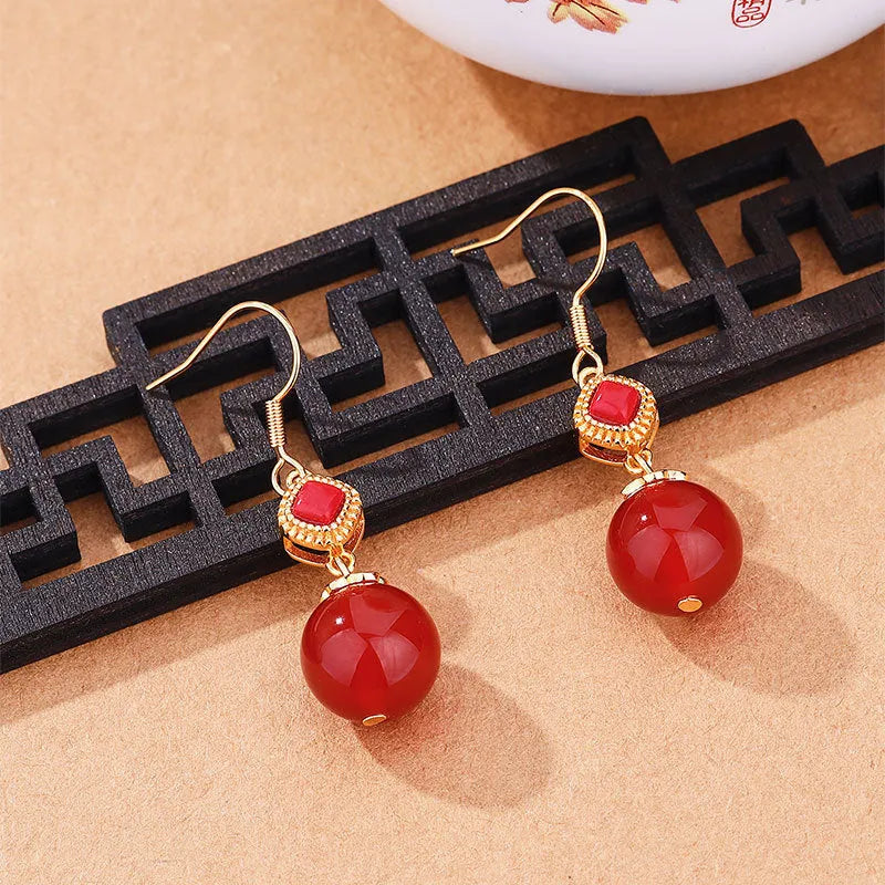 Geometric copper earrings with red agate beads and electroplated silver detailing