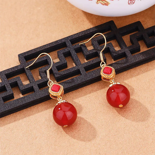 Geometric copper earrings with red agate beads and electroplated silver detailing