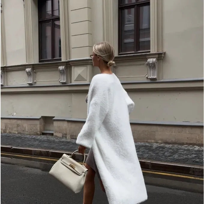 White longline women's cardigan jacket with long sleeves made from thick polyester knit fabric.