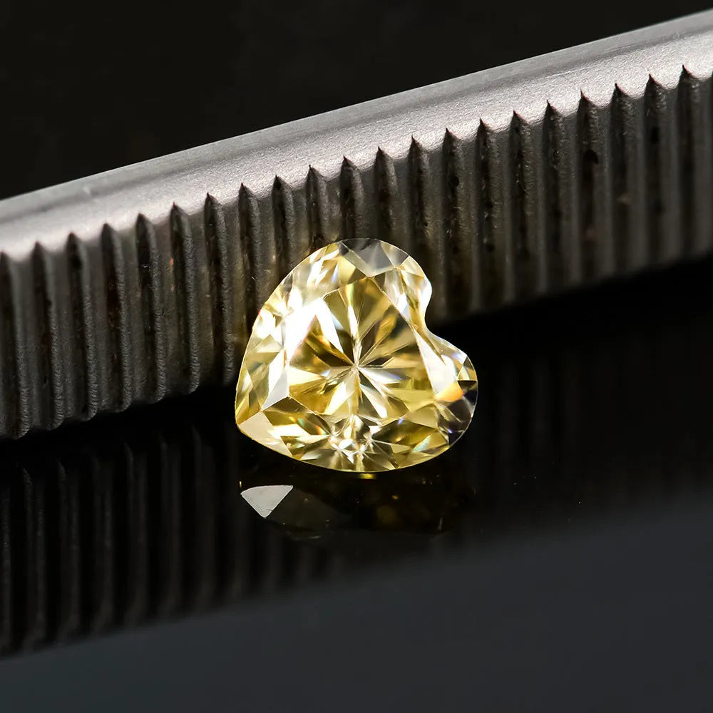 Lemon yellow heart-shaped moissanite stone with faceted surfaces