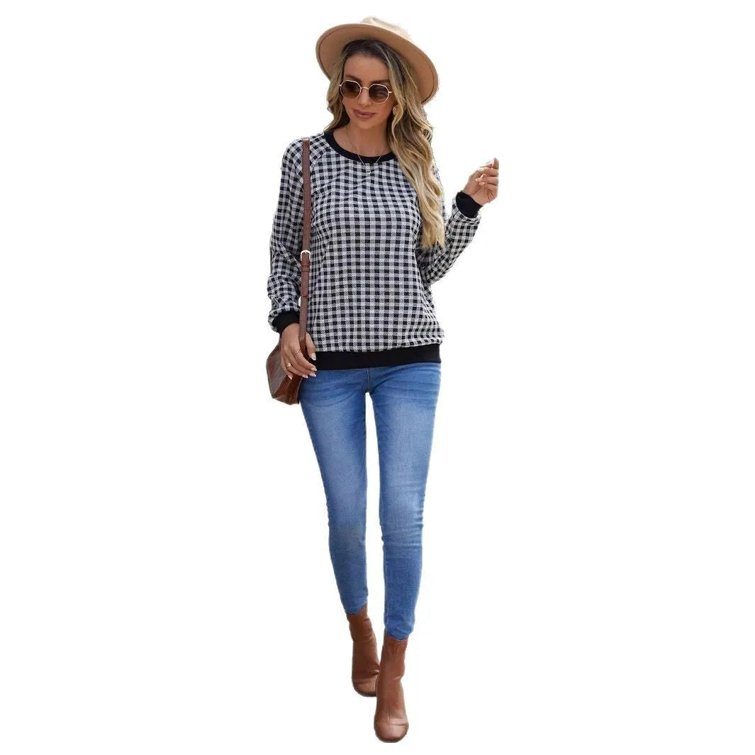 Black long sleeve pullover sweater with printed plaid and stripe pattern on a mannequin
