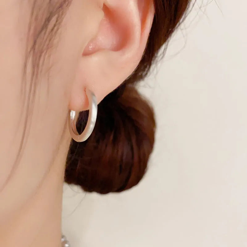 Geometric round ear clip jewellery with gold plating in minimalist style
