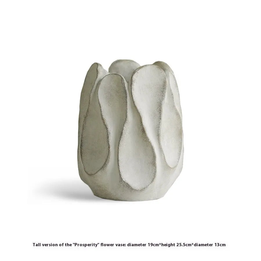 Handmade irregular ceramic vase in magnesium clay on a wooden surface.