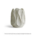 Handmade irregular ceramic vase in magnesium clay on a wooden surface.