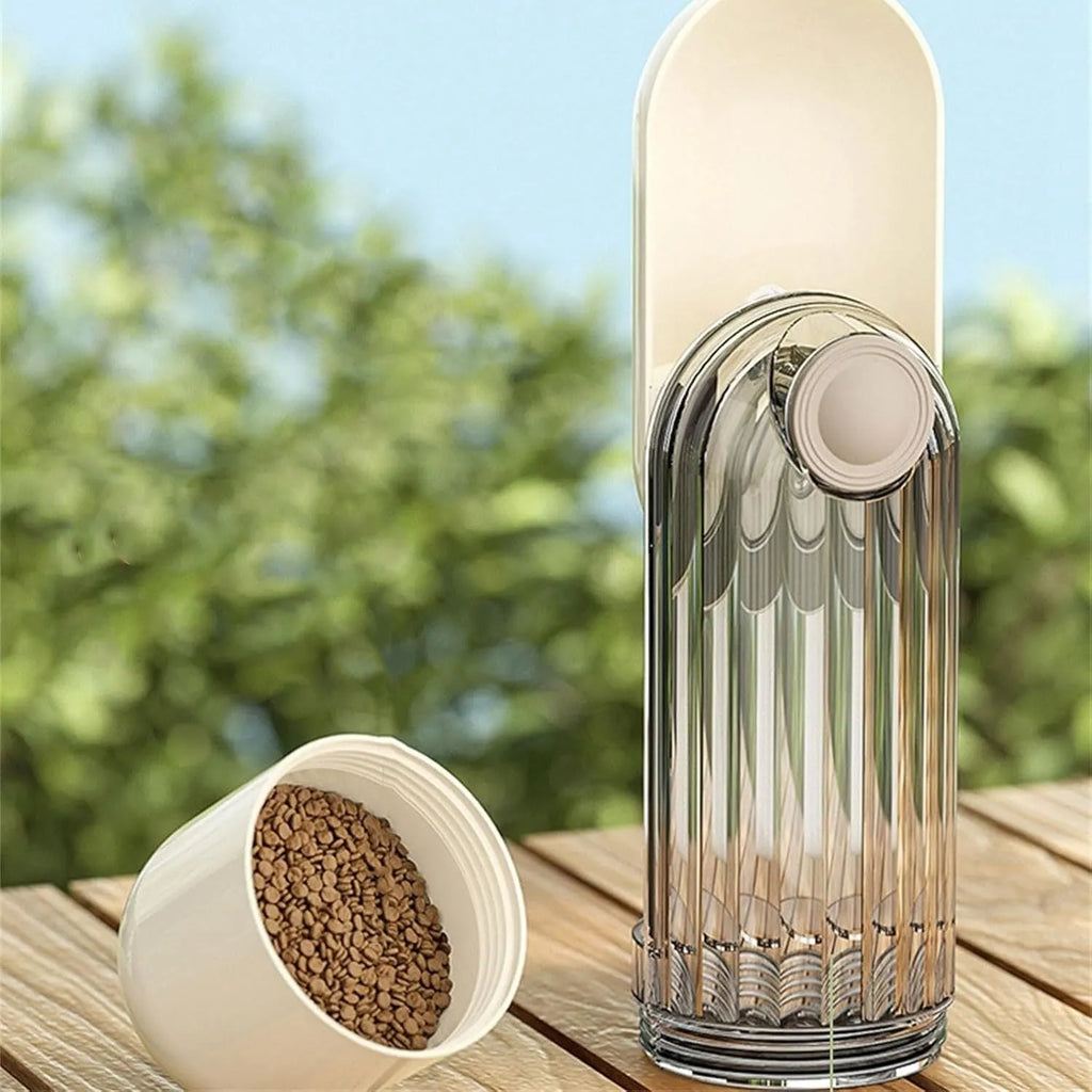 Beige foldable dog water bottle and food dispenser with tray, shown next to a dog on a walk.