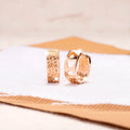 Rose gold electroplated earrings with three hollow heart shapes in circular design