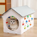 Plastic cat scratch board toy with integrated cat nest bed and tunnel, featuring a bell ball.
