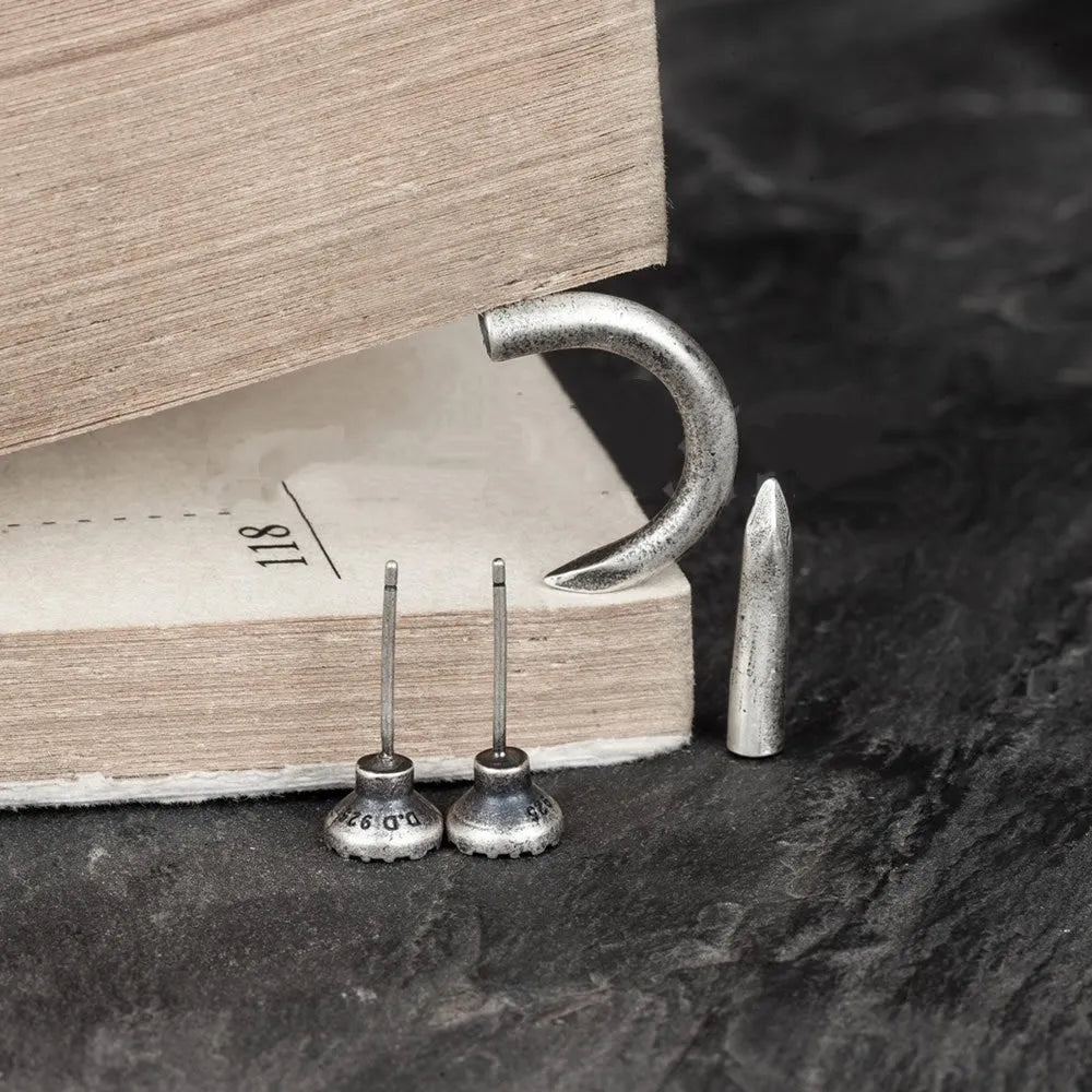 Sterling silver nail stud earrings in straight or curved punk style on ear hook.