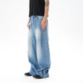 Light blue vintage washed wide leg jeans with zipper closure on mannequin