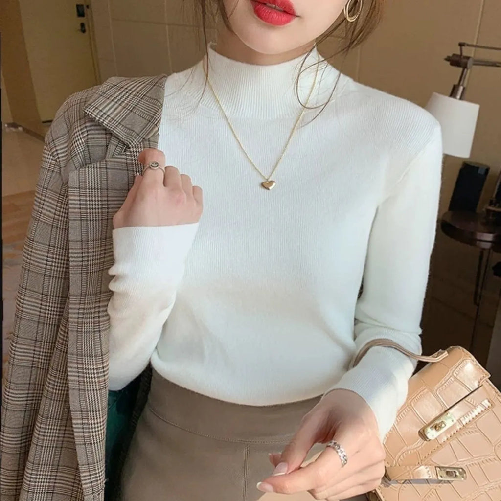 Women's slim fit long sleeve knitted pullover top in viscose fabric on a hanger.
