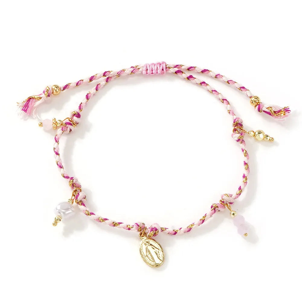 Close-up of a hand-woven colourful braided rope bracelet with an adjustable strap tag closure.