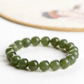 A polished Hetian jade bead bracelet in a light ice-clear colour, showing smooth round beads on a string.