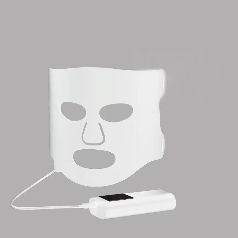 Black and white LED phototherapy face mask with controller for home skin treatment.