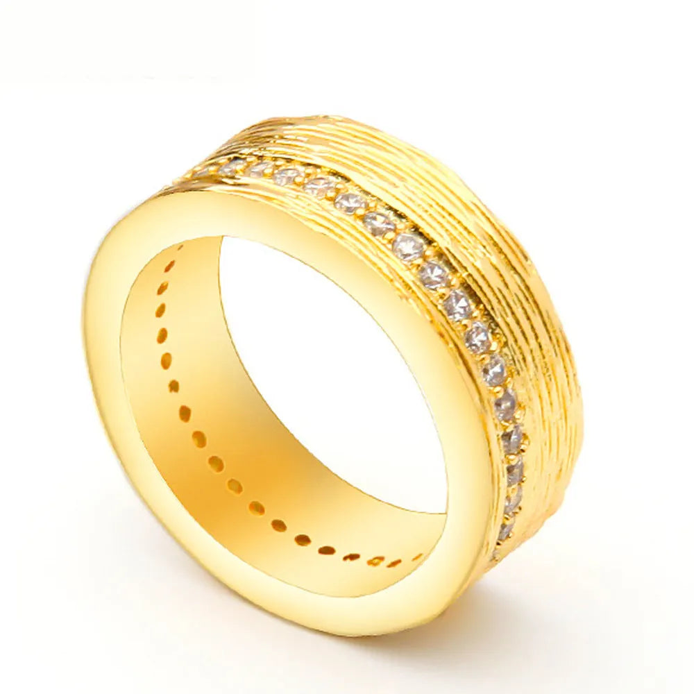 Gold-coloured geometric zircon ring for women showing openwork design and stone detail
