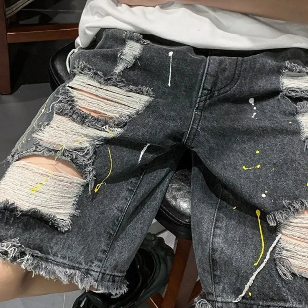 Men's loose-fit denim shorts with water-washed finish and hole detailing in light blue.