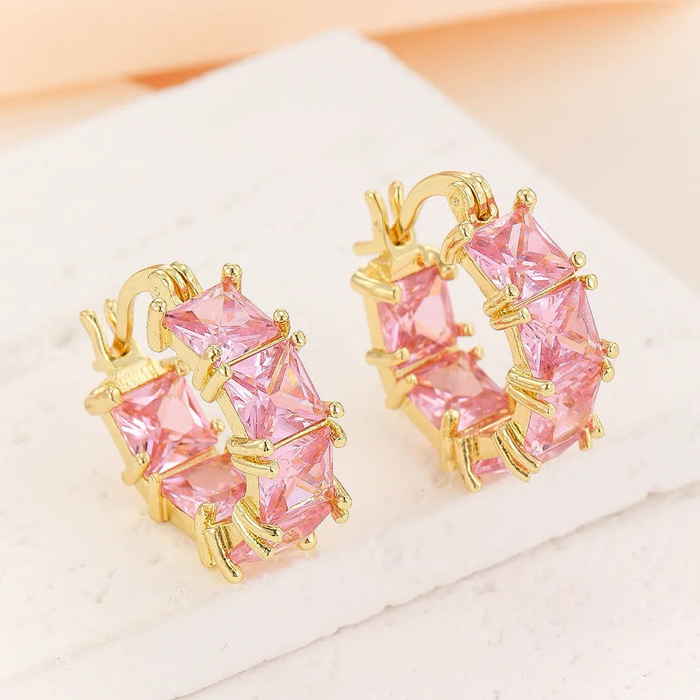 Geometric U-shaped gold ear rings with round black zircon stones