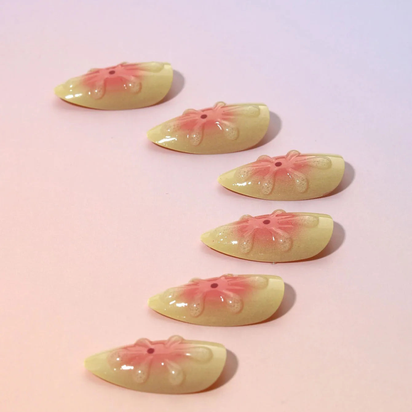 Cartoon style 3D floral plastic nail armour piece for fake nails, with jelly glue and filing strip.