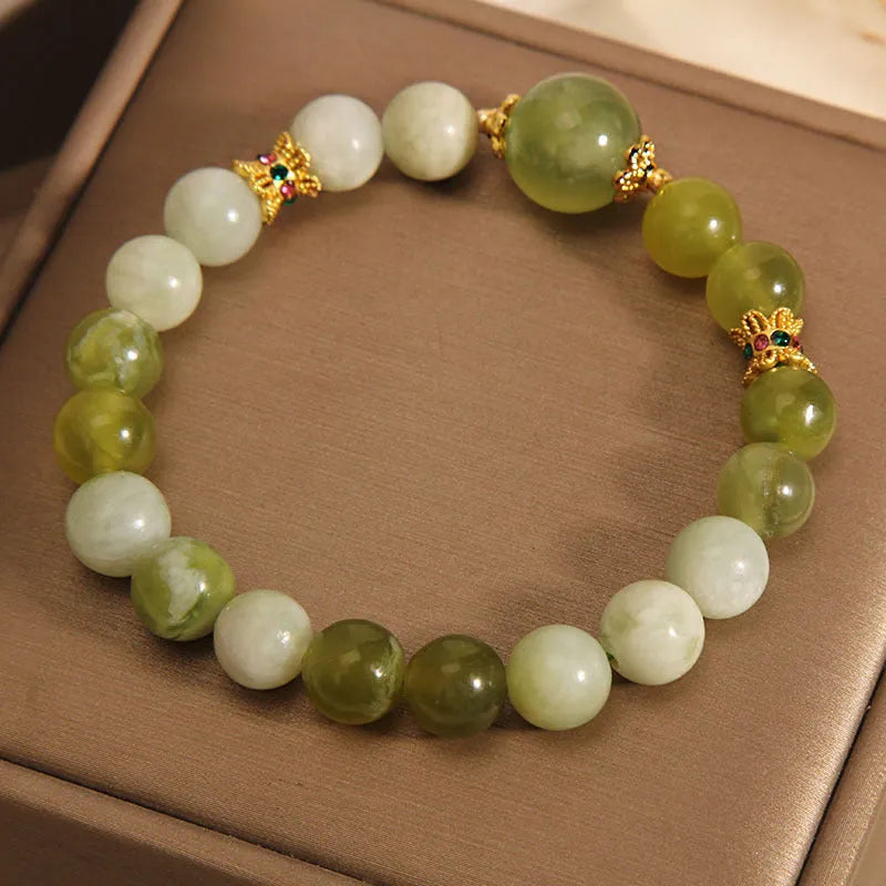 Women's bangle bracelet made from green Xiuyan jade stone with an original design.