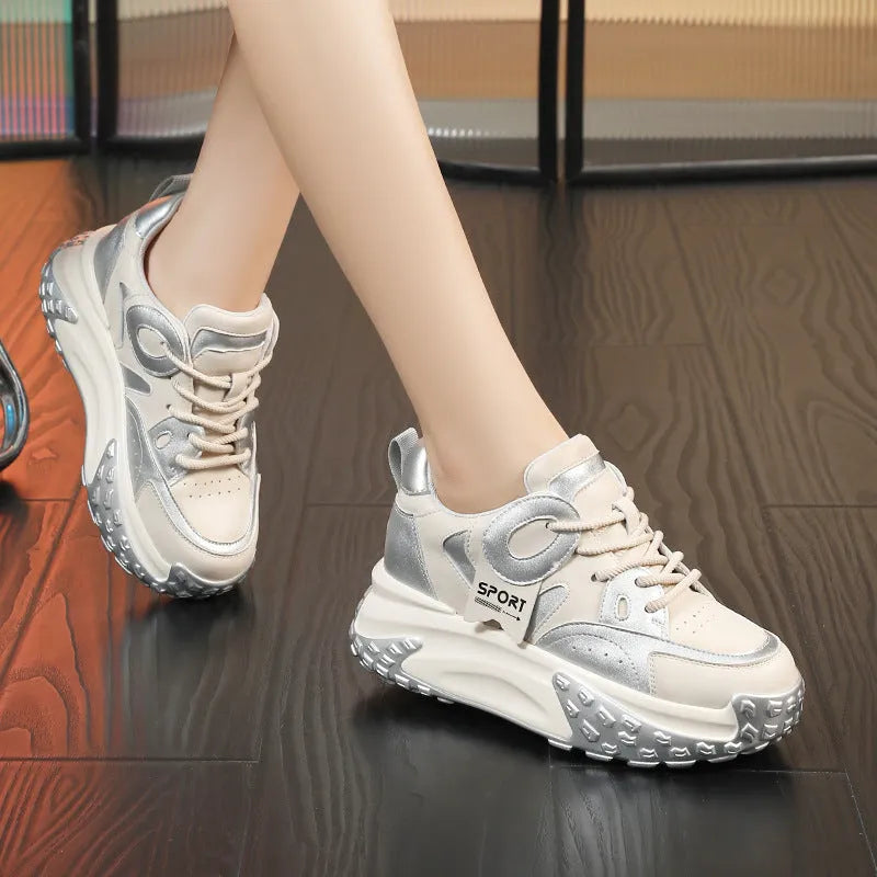 A pair of thick-soled leather casual shoes in a black and white colourway, showing the round toe and lace-up front.