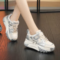 A pair of thick-soled leather casual shoes in a black and white colourway, showing the round toe and lace-up front.
