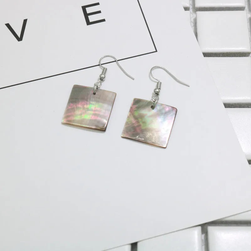 A pair of geometric-shaped women's earrings made from natural shell in a retro style.