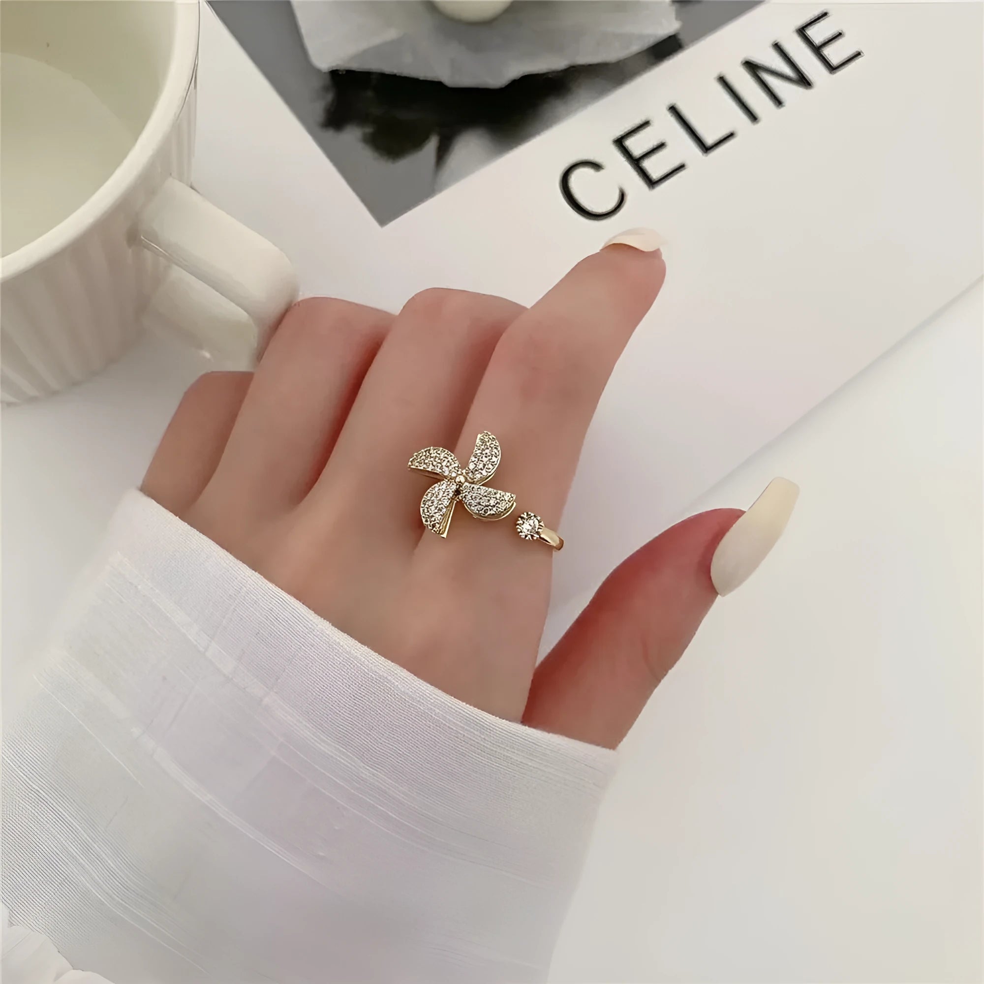 A geometric copper ring with a spinning windmill detail, shown in gold and silver electroplated finishes.