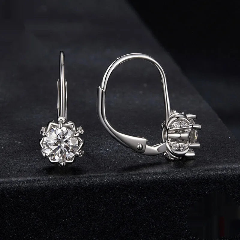 Close-up of a sterling silver flower bud clip earring with a moissanite centre, shown on a white background.