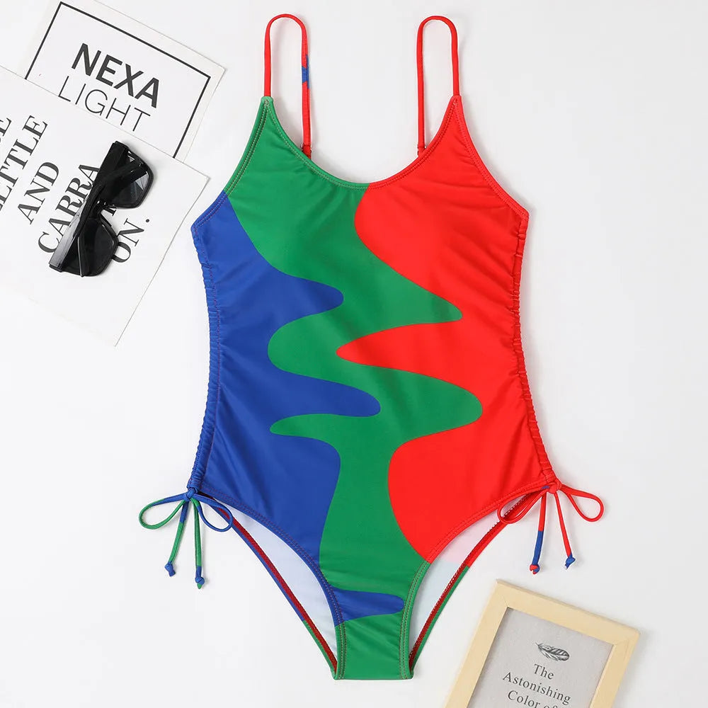 Women's sleeveless backless one-piece swimsuit in a striped pattern, shown in blue.