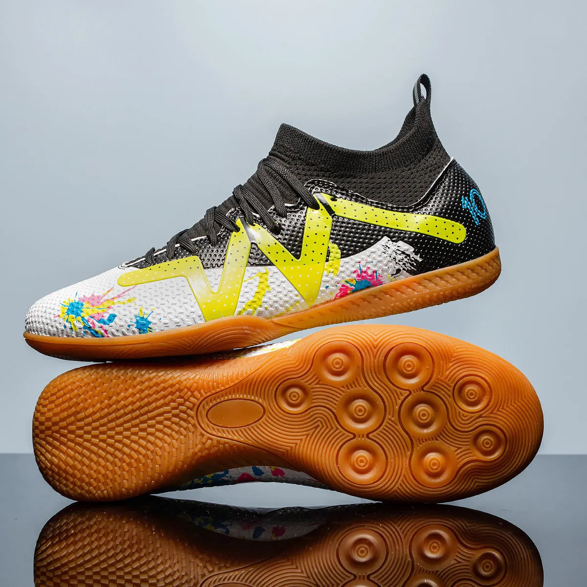 Low-top football shoes with studded rubber outsoles in black and yellow colour combination