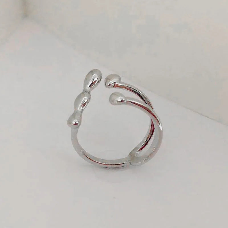 Brass opening ring with spherical design elements in gold finish