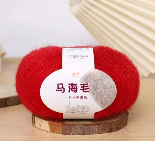 DIY mohair scarf weaving kit showing one wool ball and a selection of 34 colour options including white, pink, blue and green.