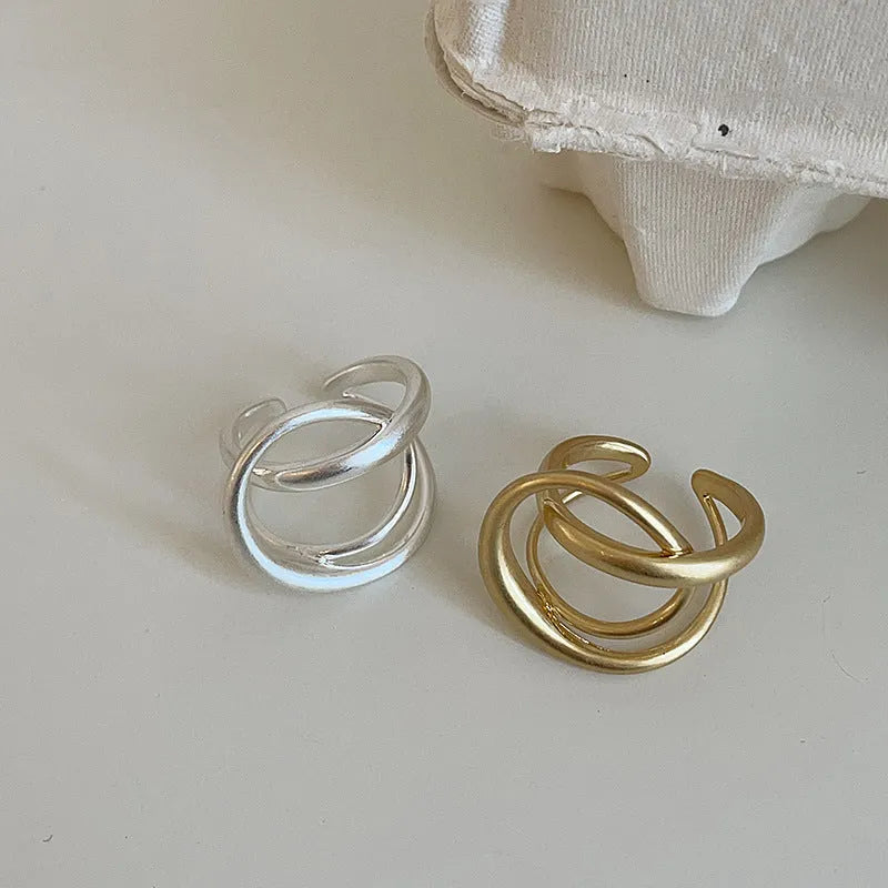 Geometric interlaced matte metal open ring for women in gold or silver.
