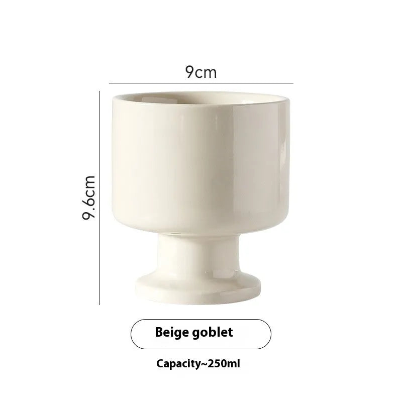 Hand-pinched irregular ceramic mug in a solid colour, showing unique handmade shape.