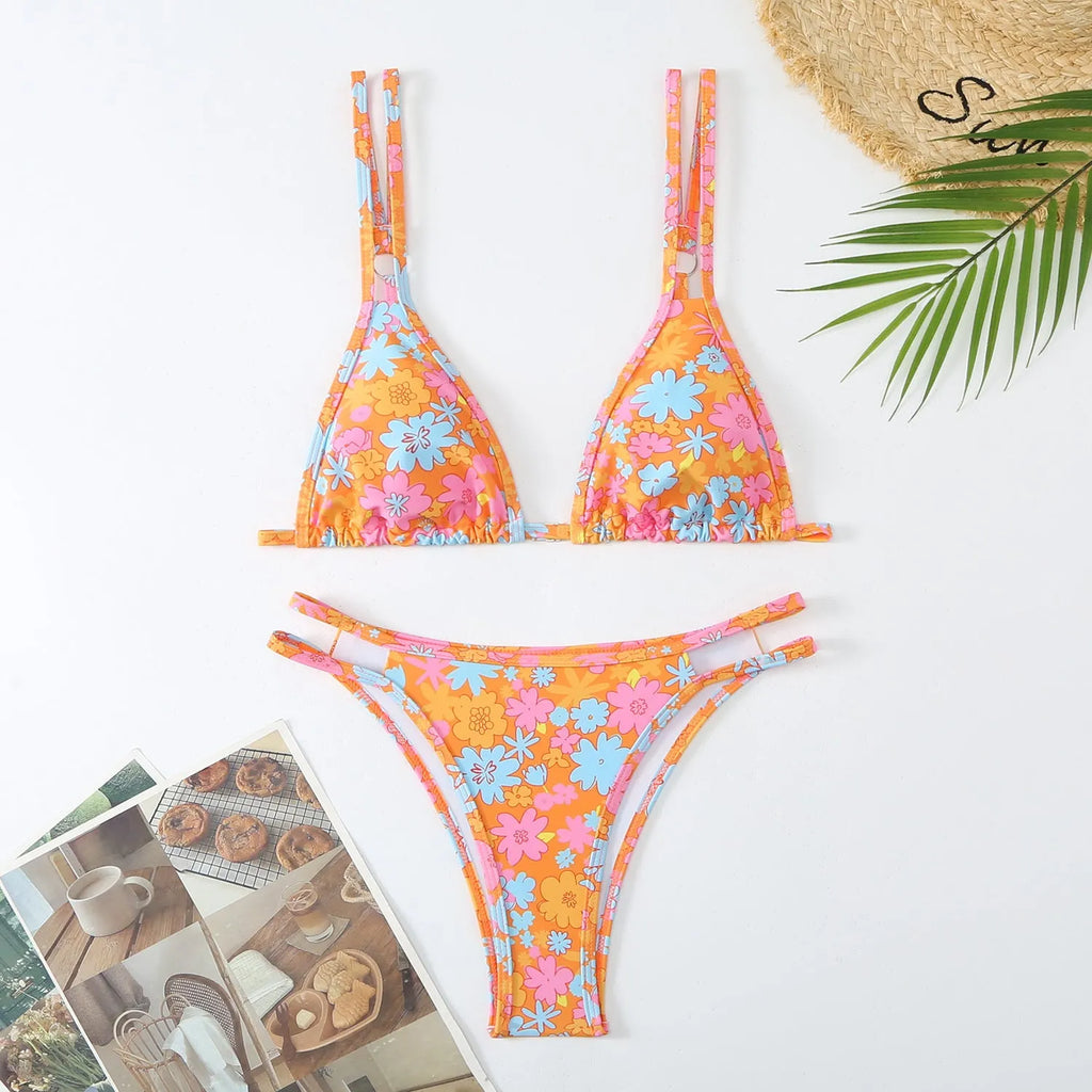 Women's printed halter polyester bikini set in blue, showing top and briefs with a floral pattern.