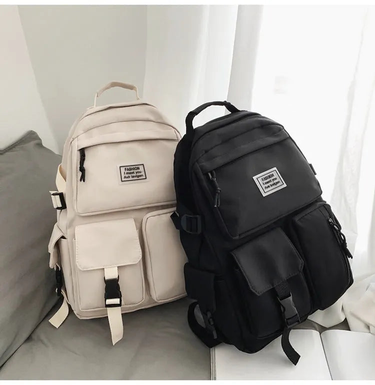 Soft nylon student backpack in black or white with computer compartment and three-dimensional pockets