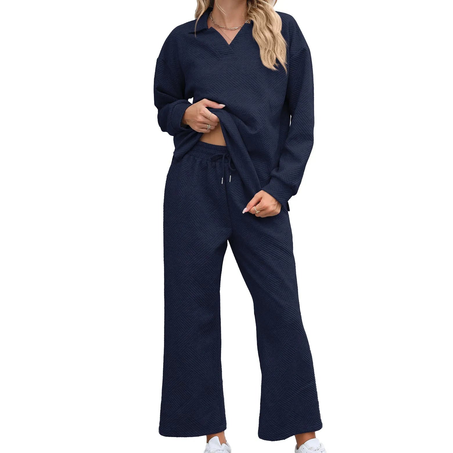 Women's black geometric pattern knitted suit set with long sleeve top and elastic waist cropped trousers.
