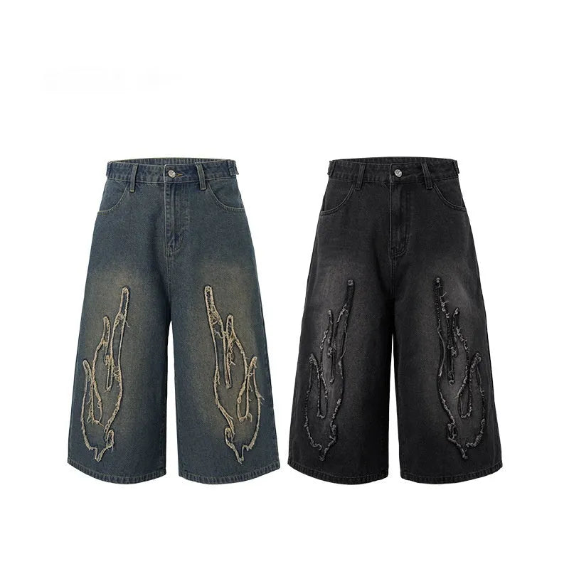 Men's black denim shorts with flame embroidery and cropped patch design on straight-leg cut