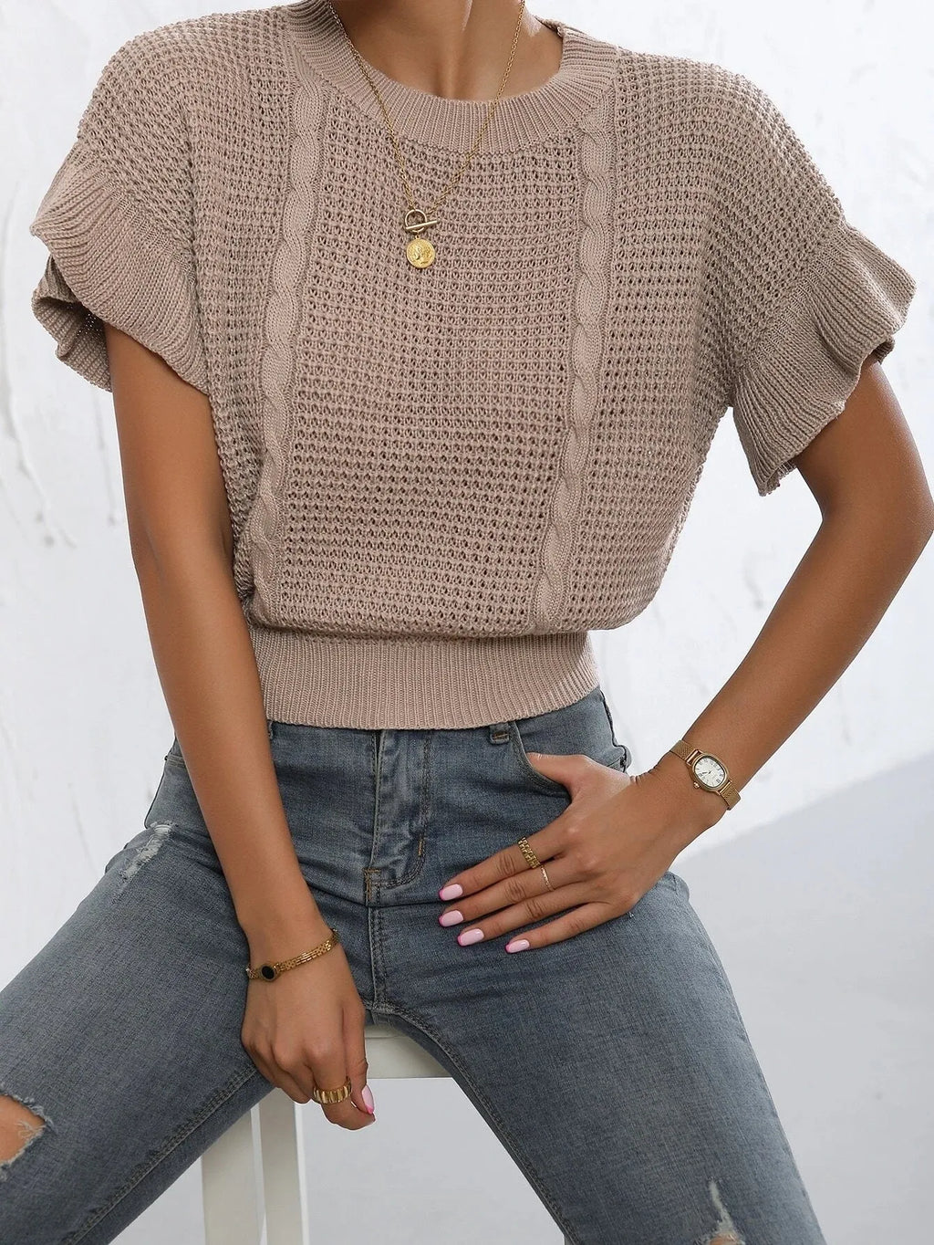 Loose fit knitted pullover sweater with ruffled short sleeves and twisted string design detailing