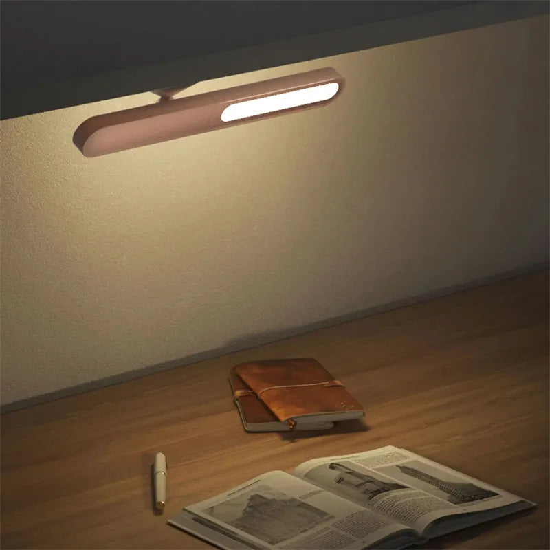Geometric wireless table lamp with magnetic base in white colour showing touch controls