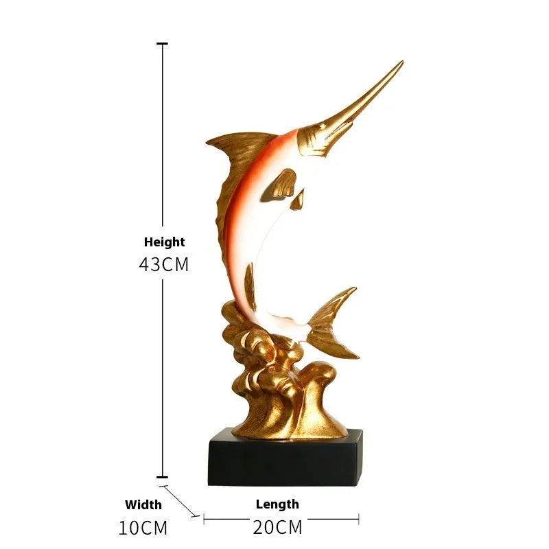 Close-up of a detailed resin European swordfish ornament in bright gold colour on a shelf.