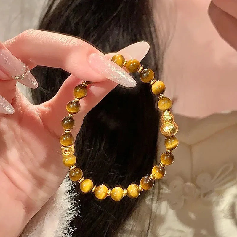 Natural yellow Tiger's Eye Hetian Jade bracelet in U-shape with gold gourd charm.